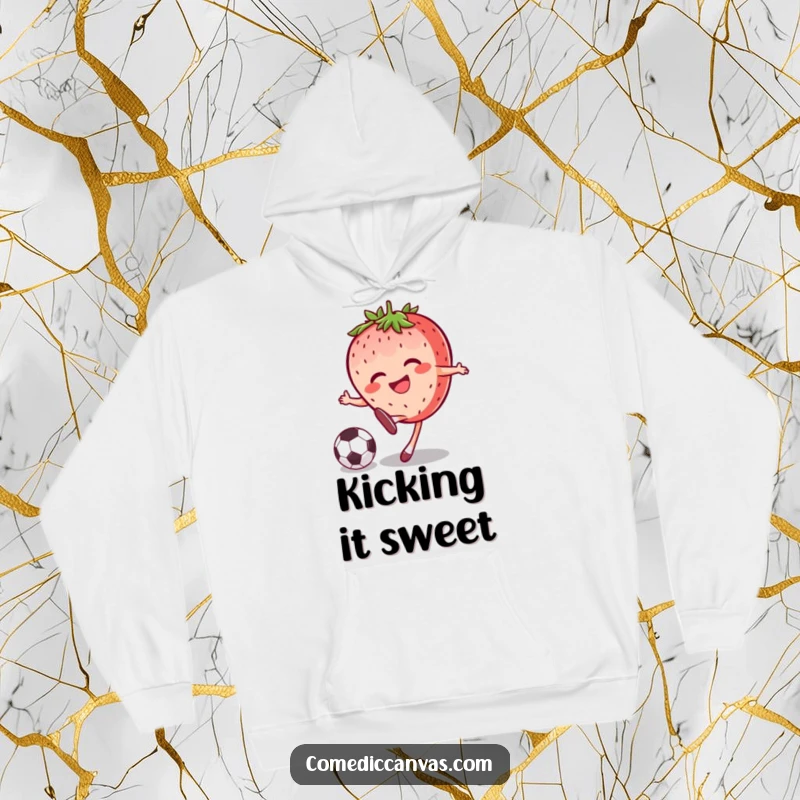 Funny joyful strawberry character kicking a soccer ball with a grin, designed for warmth and sporty fun on this hoodie.